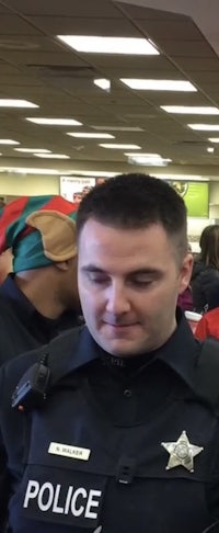 a police officer talking to a group of people in a store