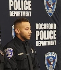 three police officers standing in front of a banner