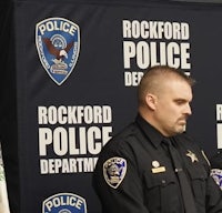 two police officers standing in front of a podium