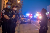 a group of police officers standing on a street at night