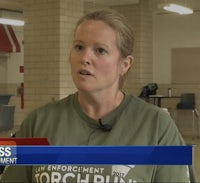 a woman in a green shirt is talking on the news